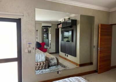 A reflection of Tv in bedroom